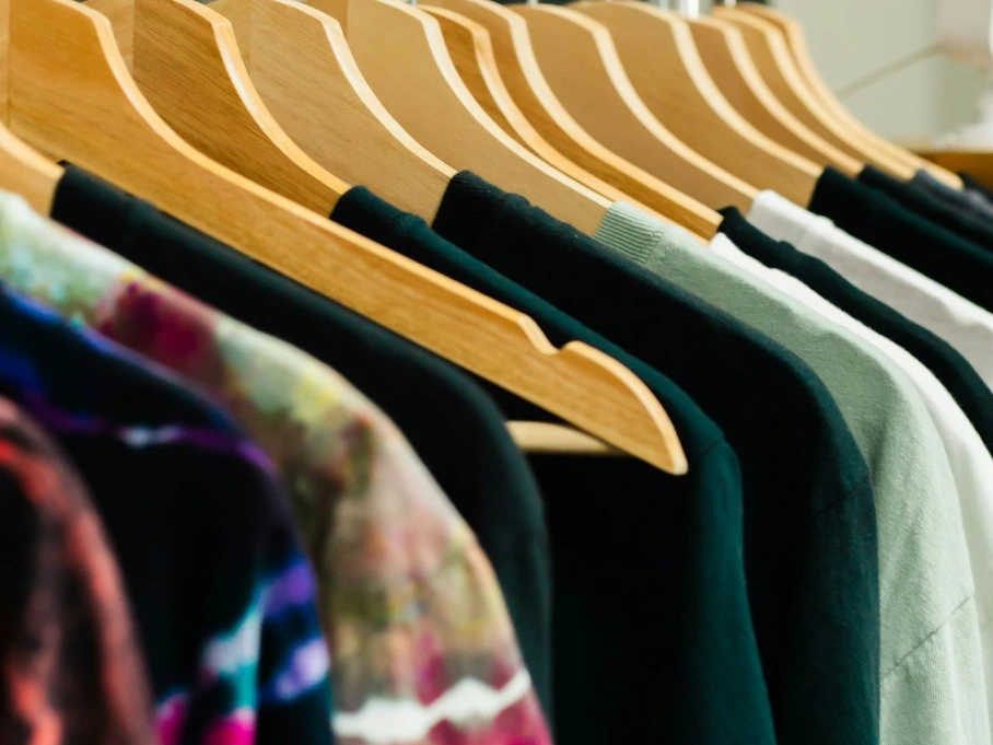 T-shirts on hangers in a retail display.