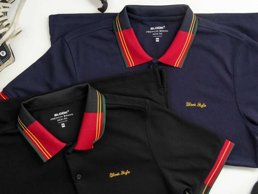 a pair of shoes and a polo shirt on a table