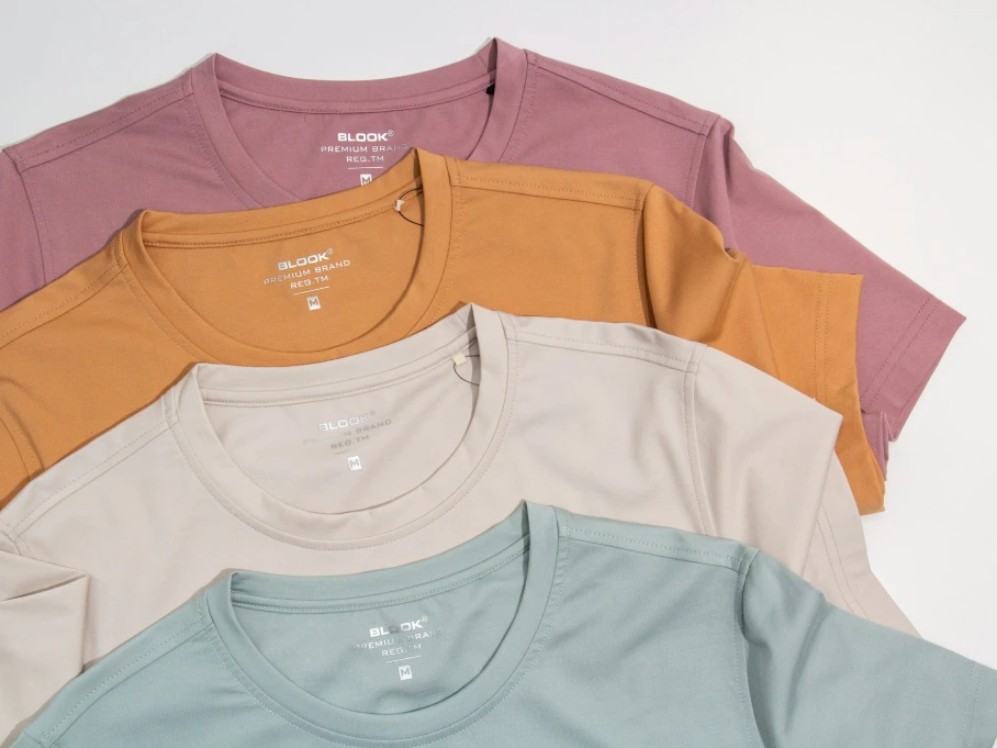 a bunch of different colored shirts on a white background
